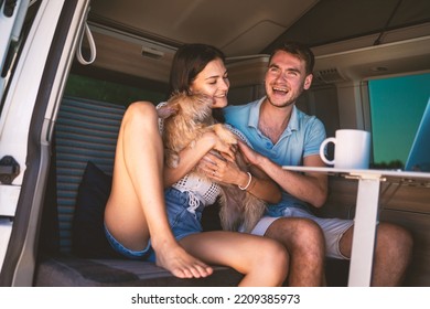 Young Couple Portrait With Dog Inside Van. Romantic Lifestyle Real Image Of Vacation On The Road. Shallow Depth Of Field.