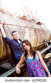 A Young Couple Poses For Some Engagement Photos In Urban Outdoor Settings.