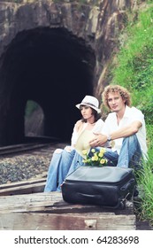 Young couple posing on a train tracks