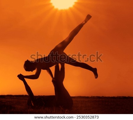 Similar – Two sisters doing gymnastics at sunset