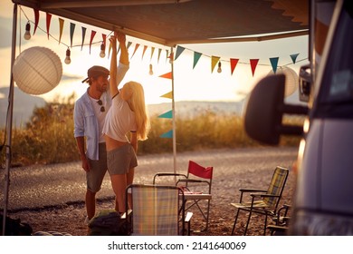 Young couple  preparing party by car outdoors in campsite