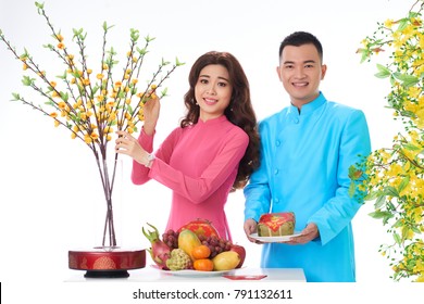 Young couple preparing table for spring festival celebration