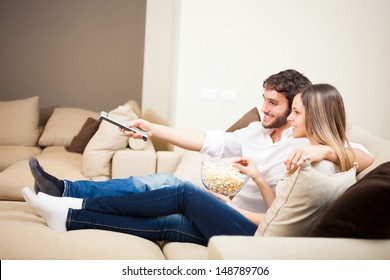 Young Couple Preparing To Watch A Movie