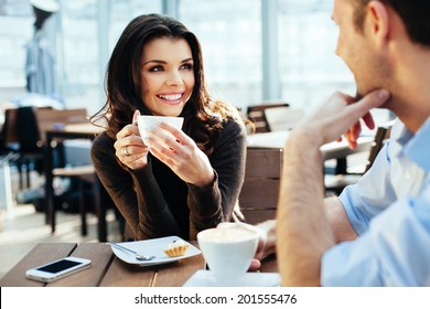 Young couple of professionals chatting during a coffee break - Powered by Shutterstock