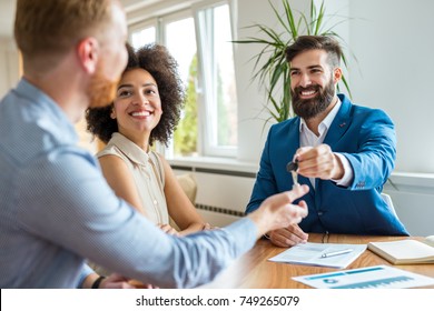 Young Couple With A Real Estate Agent.