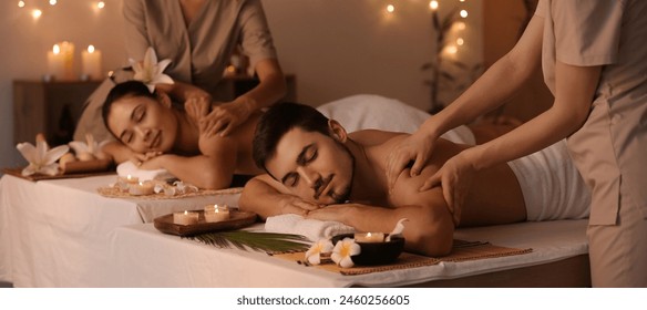 Young couple receiving massage in spa salon - Powered by Shutterstock