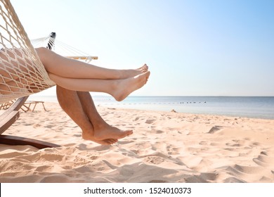 Young couple relaxing in hammock on beach, closeup - Powered by Shutterstock