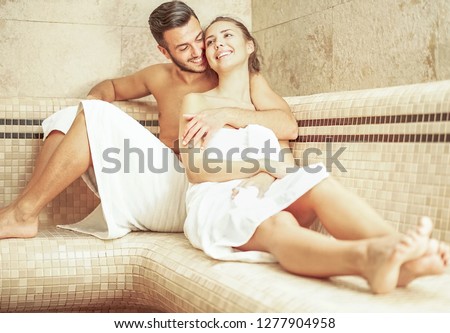 Young couple relaxing inside spa sauna room - Romantic lovers enjoying vacation day doing body treatment in luxury resort hotel - Relationship, relax, recreation and wellness lifestyle concept