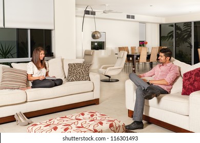 Young couple relaxing in modern living room.