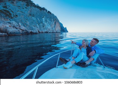 Young Couple Relaxing On A Yacht. Happy Wealthy Man And A Woman By Private Boat Have Sea Trip.