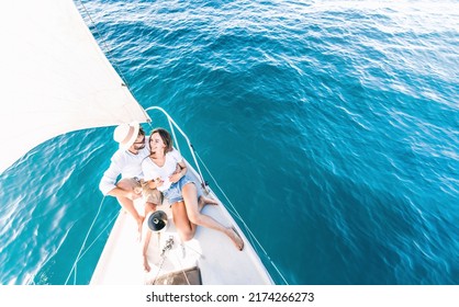 Young couple relaxing on yacht cruise - Two lovers enjoying summer vacation experience on sail boat at the sea - Summertime holidays and luxury travel concept - Powered by Shutterstock