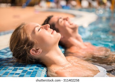 Young couple are relaxing in swimming pool. - Powered by Shutterstock