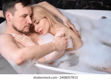 Young couple relaxing in a warm foam bath - Powered by Shutterstock