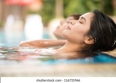 Young Couple Relaxing In Water In A Spa Resort