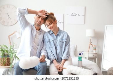 Young Couple Resting After Cleaning Their Bedroom