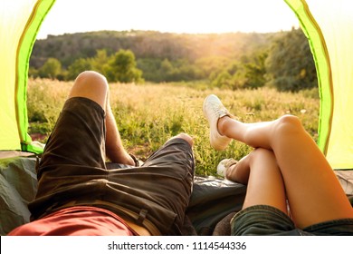 Young Couple Resting In Camping Tent, View From Inside