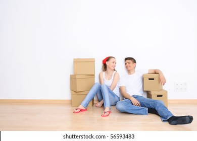 Young Couple Resting From Moving Into A New Home. Great Copy Space.