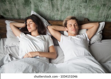 Young Couple Resting Together With Eyes Closed Sleeping Well In Comfortable Bed Before Waking Up In The Morning, Woman And Man Lying Asleep In Cozy Bedroom At Home, Healthy Good Night Sleep Concept