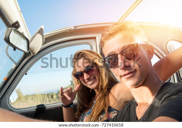 Young
couple in a retro car  at sunset, retro
style.