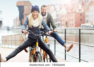 Young couple riding bikes and having fun in the city