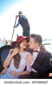 A Young Couple Riding A Gondola In Venice. Italy