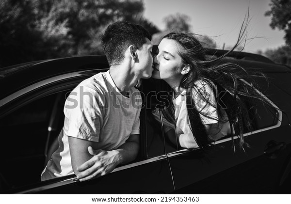 Young couple romantic\
kissing in car