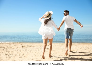 Young Couple Running On Beach Near Stock Photo 1796903989 