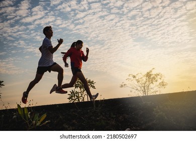 Young Couple Running On The Road Running For Fitness, Exercise, Sports, People, Exercise, Running And Lifestyle Concept. Yong Couple Jogging And Running Outdoors In Nature.