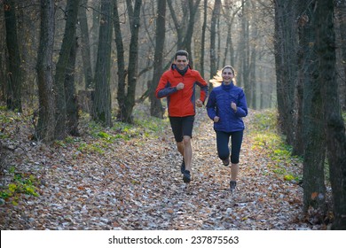 Young Couple Running on the Trail in the Wild Forest. Active Lifestyle - Powered by Shutterstock