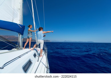 Young couple sailing in Mediterranean sea at sunny day
