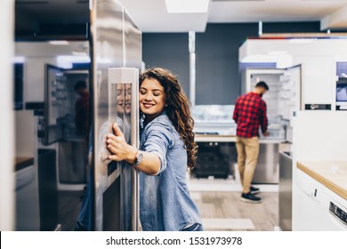 Young couple, satisfied customers choosing fridges in appliances store. - Shutterstock ID 1531973978