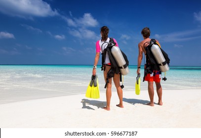 Young Couple In Scuba Diving Gear On A Tropical Beach