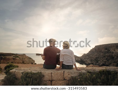 Young couple at the seaside playing guitar