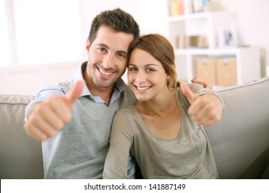 Young Couple Showing Thumbs Up