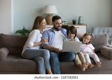 Young couple and siblings sit on couch spend leisure on internet using computer, watch favourite on-line videovlog, resting at home. Children development, modern tech, e-shopping, make order concept - Powered by Shutterstock