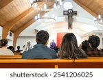 young couple sitting in the back pew of a church