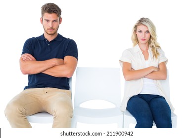 Young Couple Sitting In Chairs Not Talking During Argument On White Background