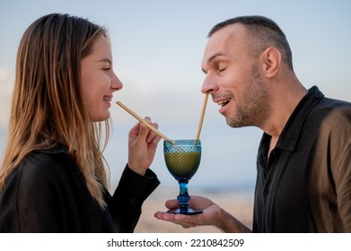 Young Couple Sitting On A Beach, Man Accidentally Gets Drinking Straw In The Nose, Meme, Fun