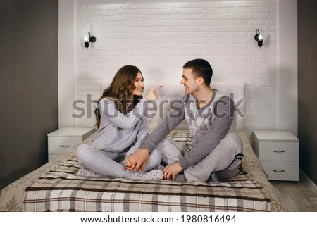 Similar – Image, Stock Photo Man showing baby clothes to pregnant woman