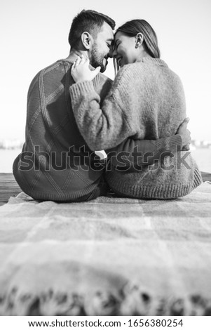 Similar – Joyful couple laughing together on a vintage sofa