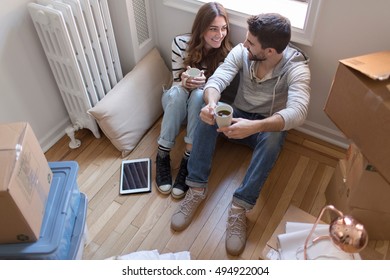 Young Couple Sitting On Fire Escape, Smiling