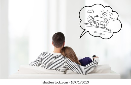 Young couple sitting on the sofa and thinking for house