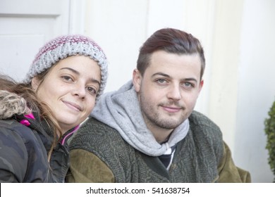 Young couple sitting outdoor Winter time in the city