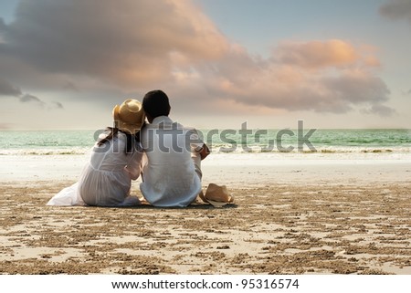 two people sitting ona beach