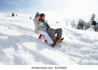 Young Couple Sledding