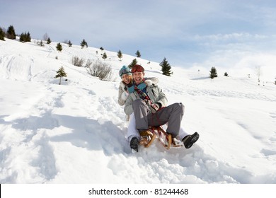 Young Couple Sledding