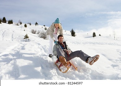 Young Couple Sledding