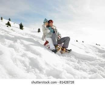 Young Couple Sledding