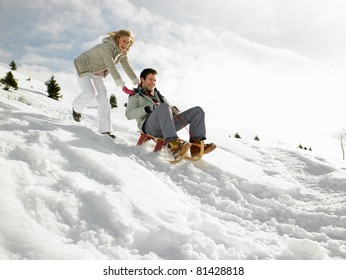 Young Couple Sledding