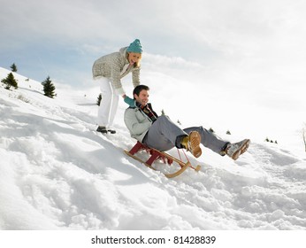 Young Couple Sledding